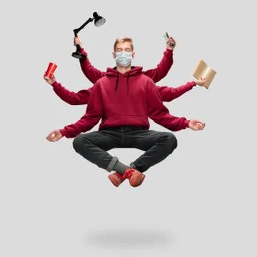 Handsome multi-armed student levitating isolated on grey studio background with Stock Photos