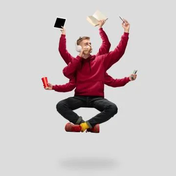 Handsome multi-armed student levitating isolated on grey studio background with Stock Photos