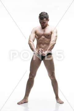 Handsome muscular bodybuilder posing on white background. Isolated studio sho Stock Photos