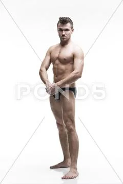 Handsome muscular bodybuilder posing on white background. Isolated studio sho Stock Photos