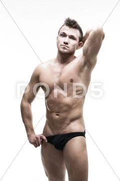 Handsome muscular bodybuilder posing on white background. Isolated studio sho Stock Photos