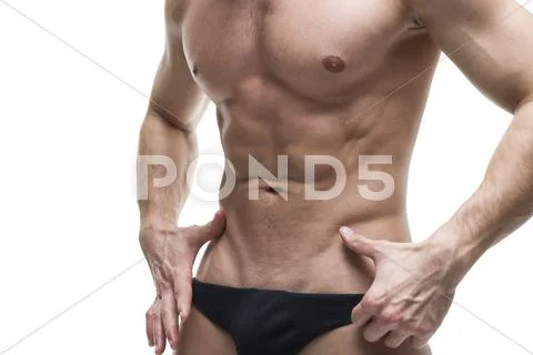 Handsome muscular bodybuilder posing on white background. High key c Stock Photos