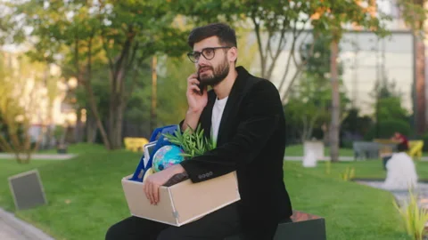 Handsome office manager with a office stuff in the box was fired from work he Stock Footage 194419472