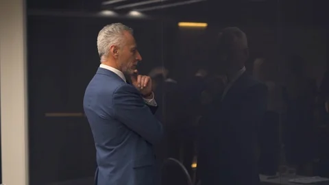The handsome old businessman posing on camera. slow motion Stock Footage 123975091