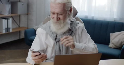 Handsome Old Gray-Haired Man browsing on Social Media using Smartphone. Senior Stock Footage 151522285