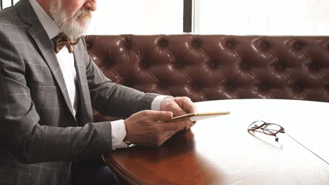 Handsome old man working on digital tablet in home office. Stock Footage 109480881
