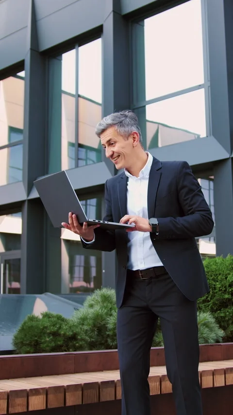 Handsome older man entrepreneur using laptop remotely computer for online busine Stock Footage 327544446
