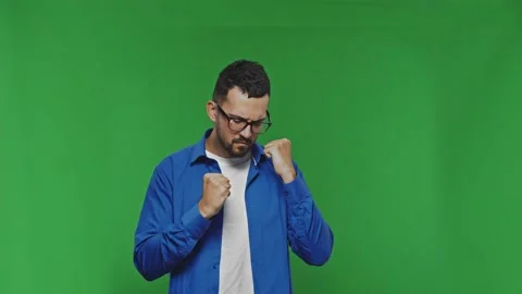 Handsome overjoyed bearded man expressing winning gesture with raised fists Stock Footage 168360873