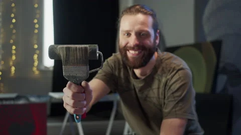A handsome painter is keeping art tools in his hand and looking at the camera Stock Footage 155222365