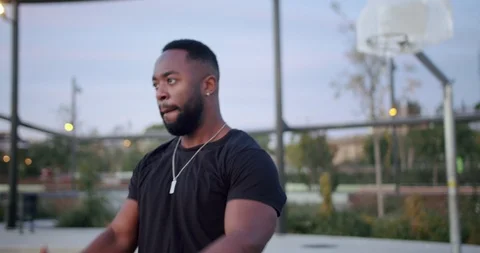 Handsome pensive African guy stretching shoulders and arms looking at camera on Stock Footage 123664540