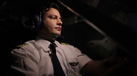 Handsome pilot flying plane, flirting with dispatcher over radio, enjoying work Stock Footage 65131573