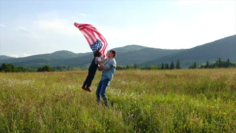 Handsome playful dad throwing his daughter in air on background mountains Stock Footage 155842669
