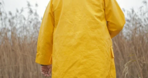 Handsome plus size young man in yellow fisherman coat jacket with fishing rod Stock Footage 103325610