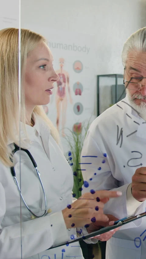 Handsome positive friendly experienced bearded doctor thanking to his blond Stock Footage 321196940