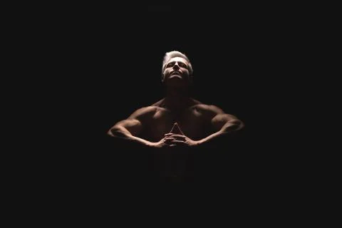 Handsome power athletic man in dramatic light. Strong bodybuilder with perfect Stock Photos