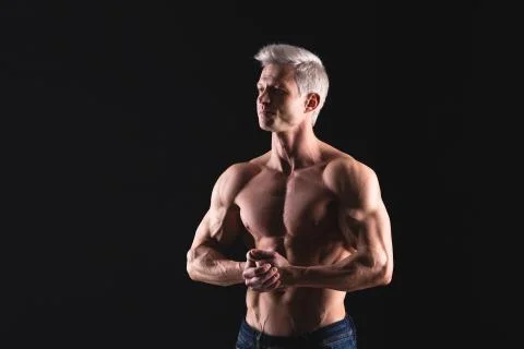 Handsome power athletic man in dramatic light. Strong bodybuilder with perfect Stock Photos