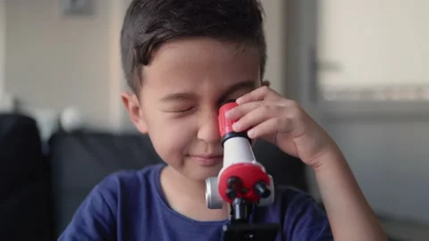 Handsome preschooler studies the microcosm through a microscope Stock Footage 204072057