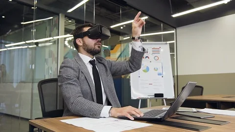 Handsome professional bearded businessman in virtual reality headset working on Stock Footage 124844375