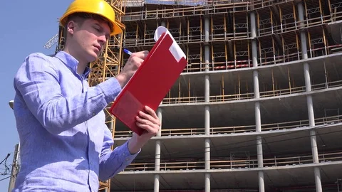 Handsome professional foreman writing blueprint plan engineering architect work Stock Footage