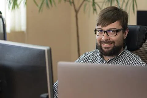 Handsome programmer sitting in front of his computer Foto stock