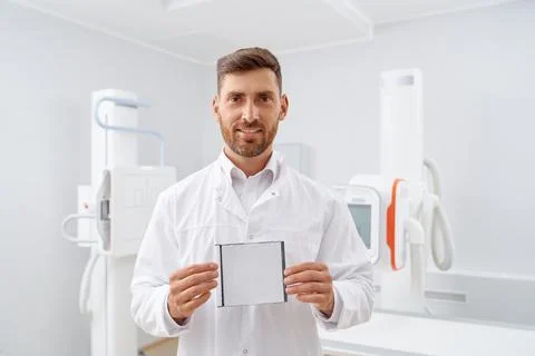 Handsome radiologist with beard box with CD plate. Stock Photos