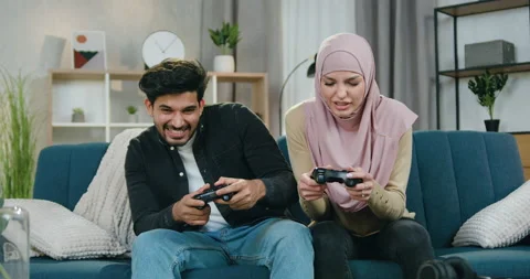 Handsome satisfied bearded guy celebrating victory in video game while his Stock Footage 150108896