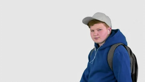 Handsome school boy walking by while listening to music, Alpha Channel Stock-Footage 151161092