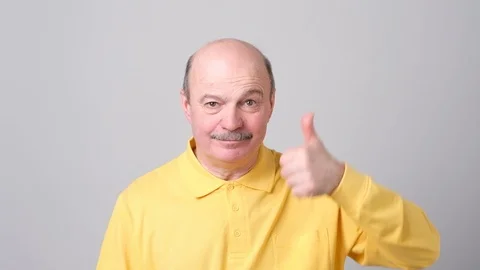 Handsome senior man shows thumb up Stock Footage 102804698