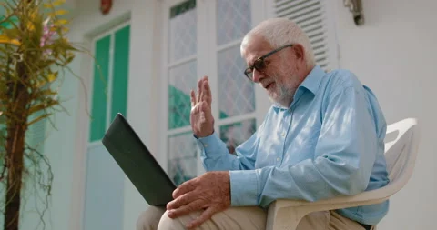 Handsome senior man talking to his family via the Internet Stock Footage 105166557
