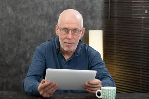Handsome senior man using tablet computer Stock Photos