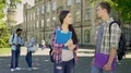 Handsome senior student flirting with beautiful asian girl on college campus 4k or 4k+ Resolution