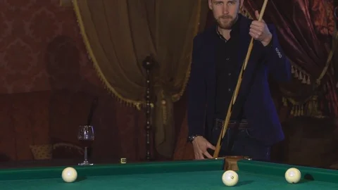 Handsome serious man playing pool Stock Footage 70431377