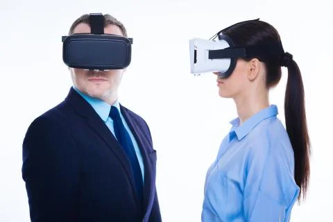 Handsome serious man standing opposite his female colleague Stock Photos