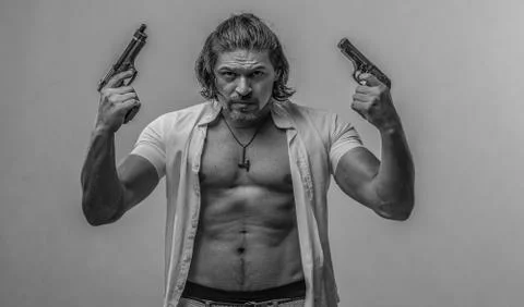 Handsome sexy man with a hand gun Stock Photos