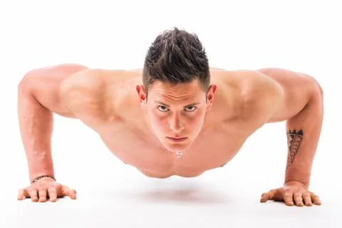 Handsome shirtless bodybuilder doing push-ups in studio shot Stock Photos