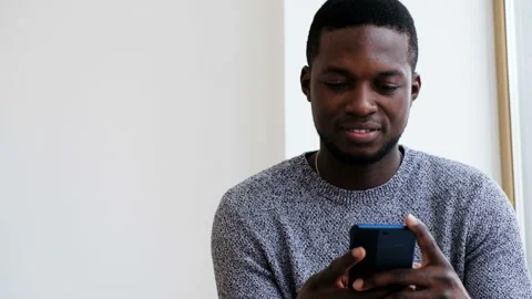 Handsome smiling African student guy having positive emotions looking on screen Stock Footage 109154871