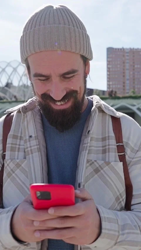 Handsome smiling Caucasian man using mobile in science park in Valencia city Stock Footage 276390302