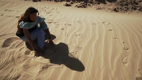 Handsome smiling female extatic dancing on sand dune in desert slow motion Stock Footage 108287281
