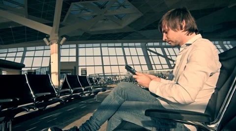 Handsome smiling man holding tablet and working at the airport, technology Stock-Footage 66482297