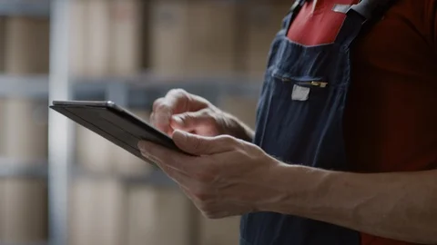 Handsome Smiling Warehouse Worker Uses Digital Tablet For Checking Stock. Video stock 96145369