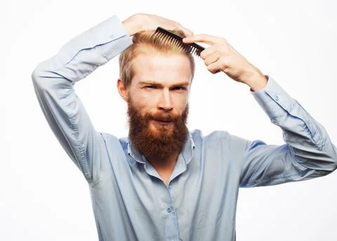 Handsome smiling young man doing modern hairstyle Stock Photos