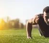 The handsome sportsman pushing up on the grass Photo