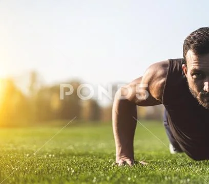 The handsome sportsman pushing up on the grass Stock Photos