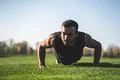 The handsome sportsman pushing up on the grass Photo