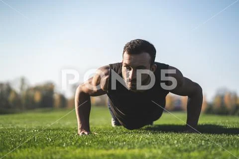 The handsome sportsman pushing up on the grass Stock Photos