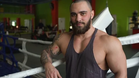 Handsome sporty man smile and posing into camera in fitness club Stock Footage