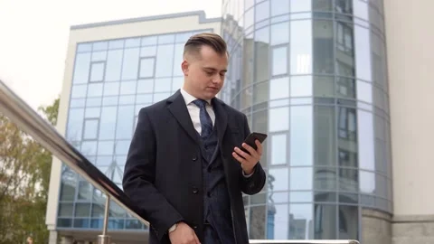 Handsome startup businessman using mobile phone. Young man texting messages Stock Footage 144061540