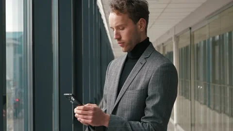 Handsome startup businessman using mobile Phone. Young man texting messages Stock Footage 146020559