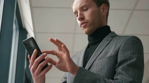 Handsome startup businessman using mobile Phone. Young man texting messages Stock Footage 146020829