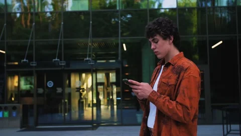 Handsome Startup Businessman using mobile Phone. Young man texting Messages Stock Footage 243843115